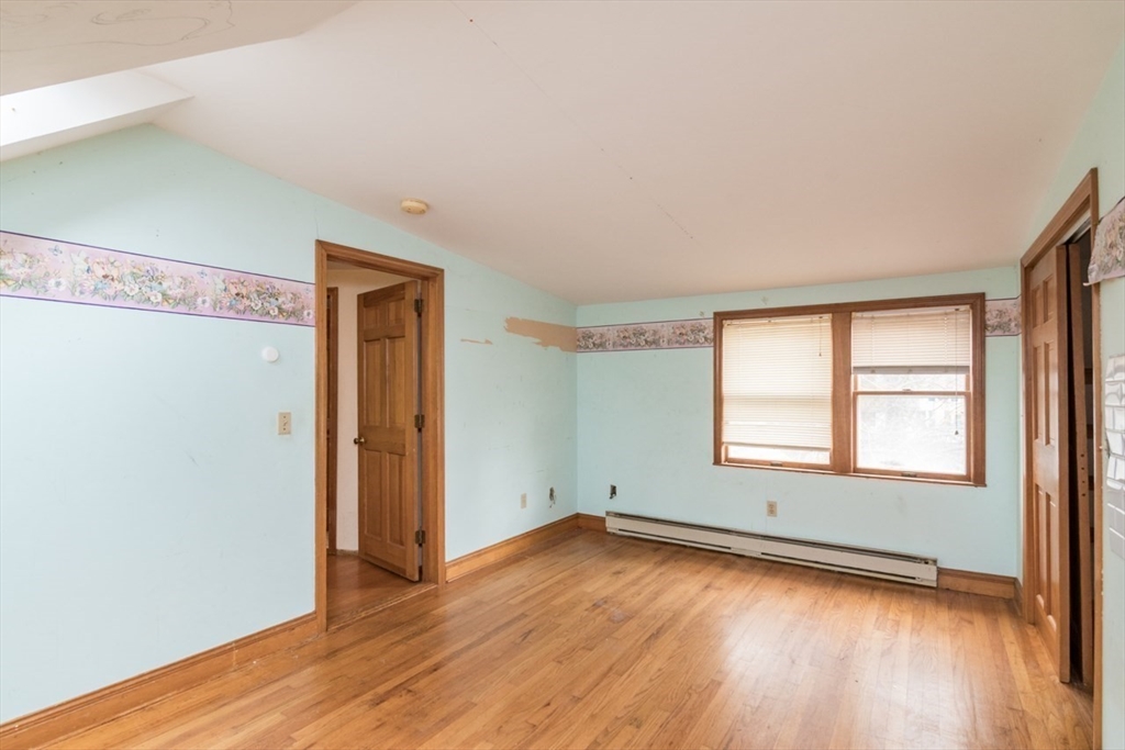 110 Old Amherst Road Sunderland, MA 01375 - Photo 25 of 41 an empty room with wooden floor and windows