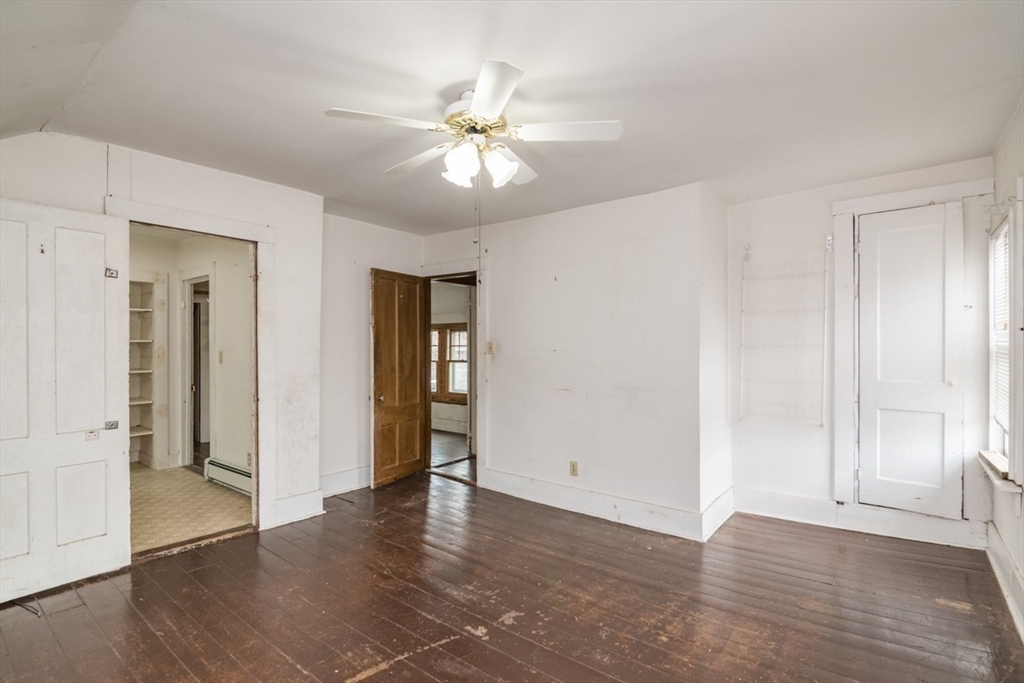 110 Old Amherst Road Sunderland, MA 01375 - Photo 30 of 41 an empty room with wooden floor and ceiling fan