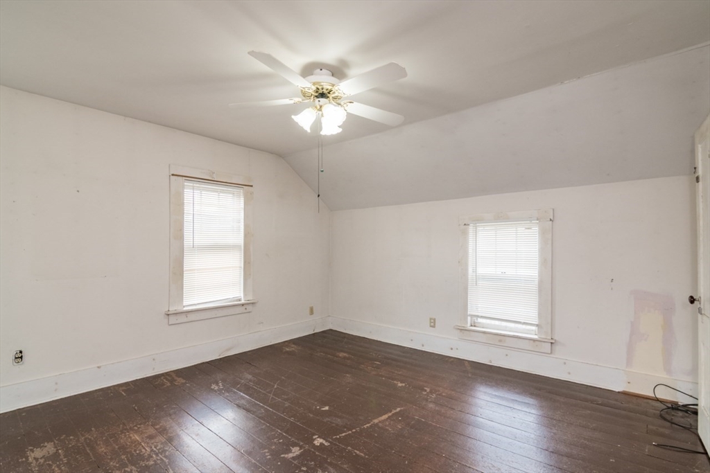 110 Old Amherst Road Sunderland, MA 01375 - Photo 31 of 41 an empty room with wooden floor chandelier fan and windows