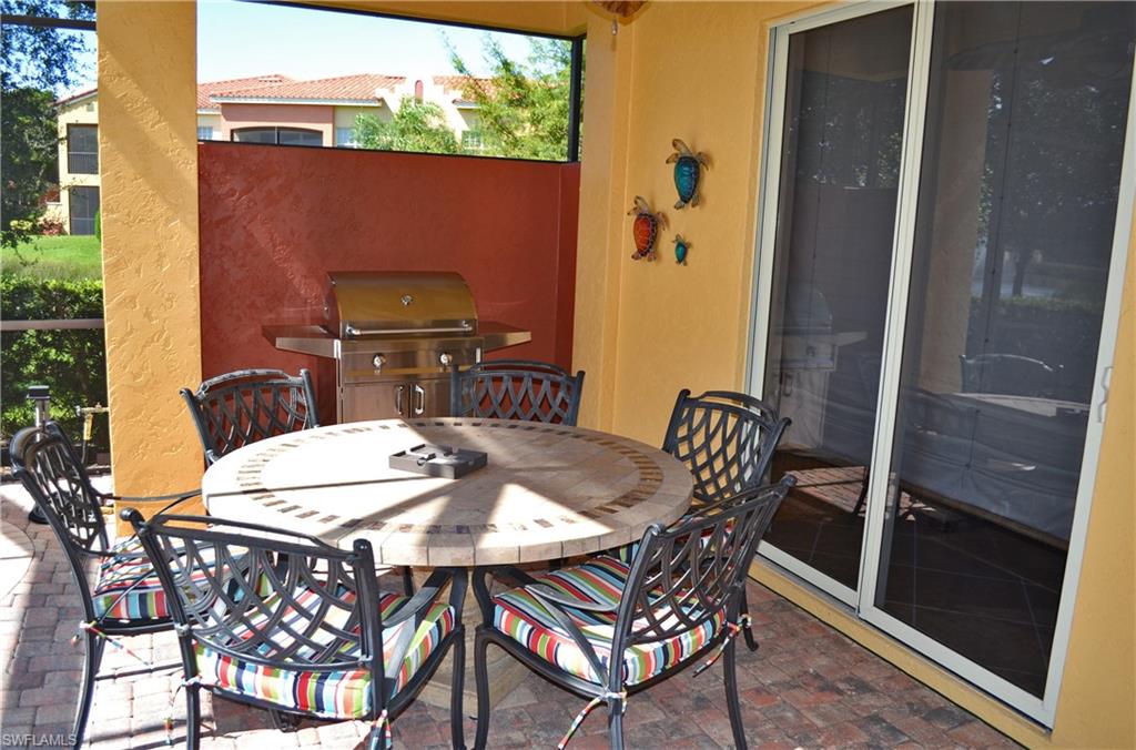 22160 Ponte Romano Lane Estero, FL 33928 - Photo 13 of 17 a view of a balcony dining table and chairs