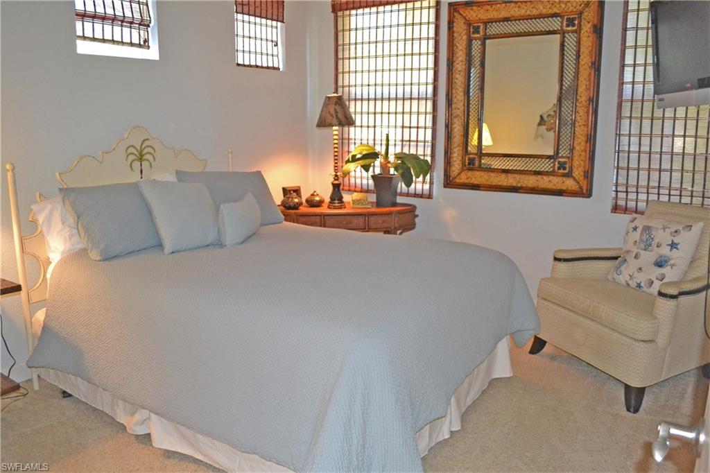 22160 Ponte Romano Lane Estero, FL 33928 - Photo 9 of 17 a bedroom with a bed and wooden floor