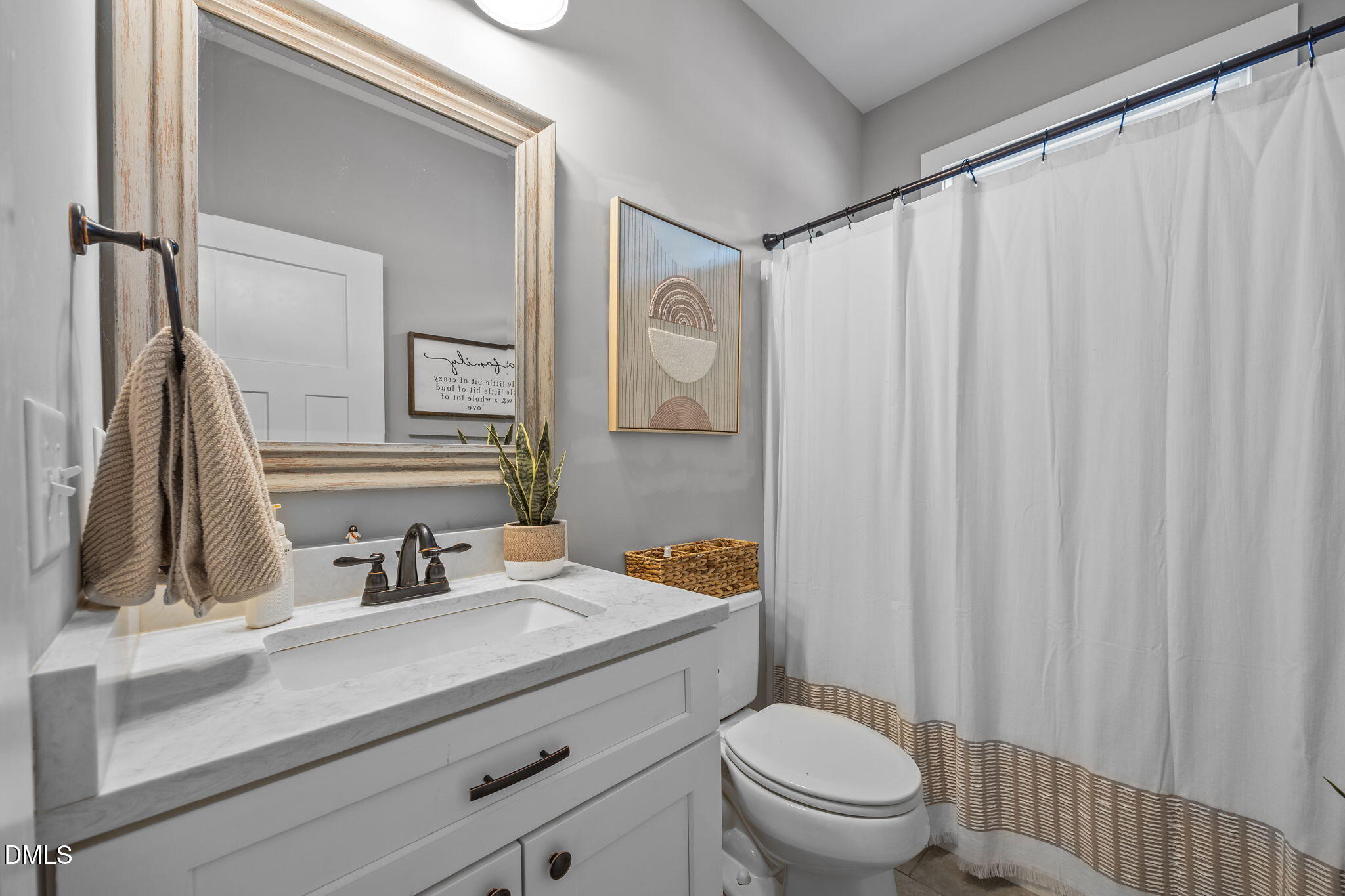 2265 Lacy Holt Road Graham, NC 27253 - Photo 17 of 43 a bathroom with a sink a toilet and a mirror