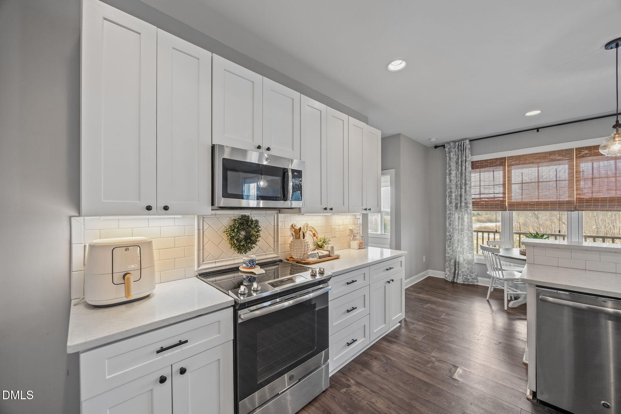 2265 Lacy Holt Road Graham, NC 27253 - Photo 20 of 43 a kitchen with a stove and a white cabinets