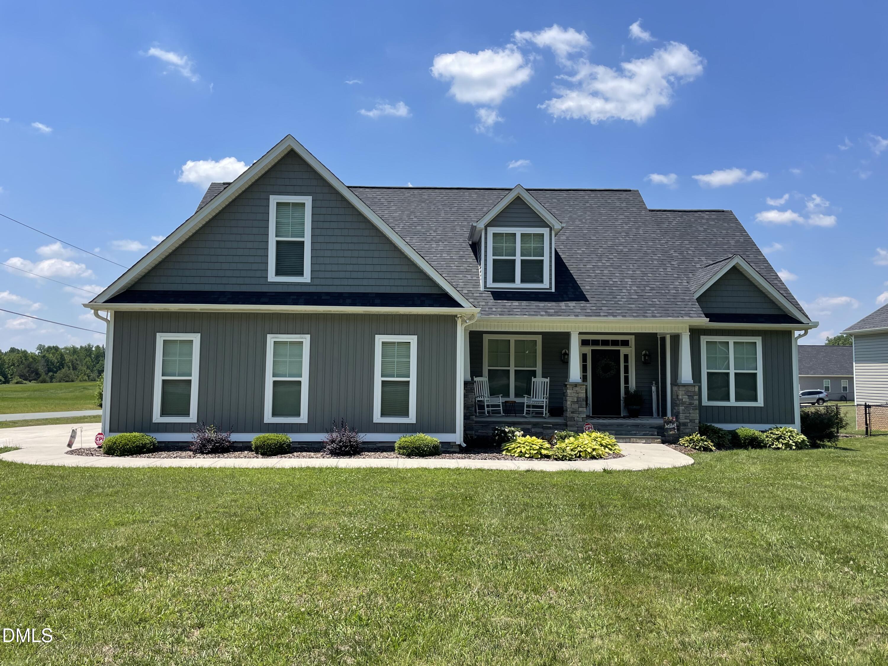 2265 Lacy Holt Road Graham, NC 27253 - Photo 2 of 43 a front view of a house with a yard table and chairs