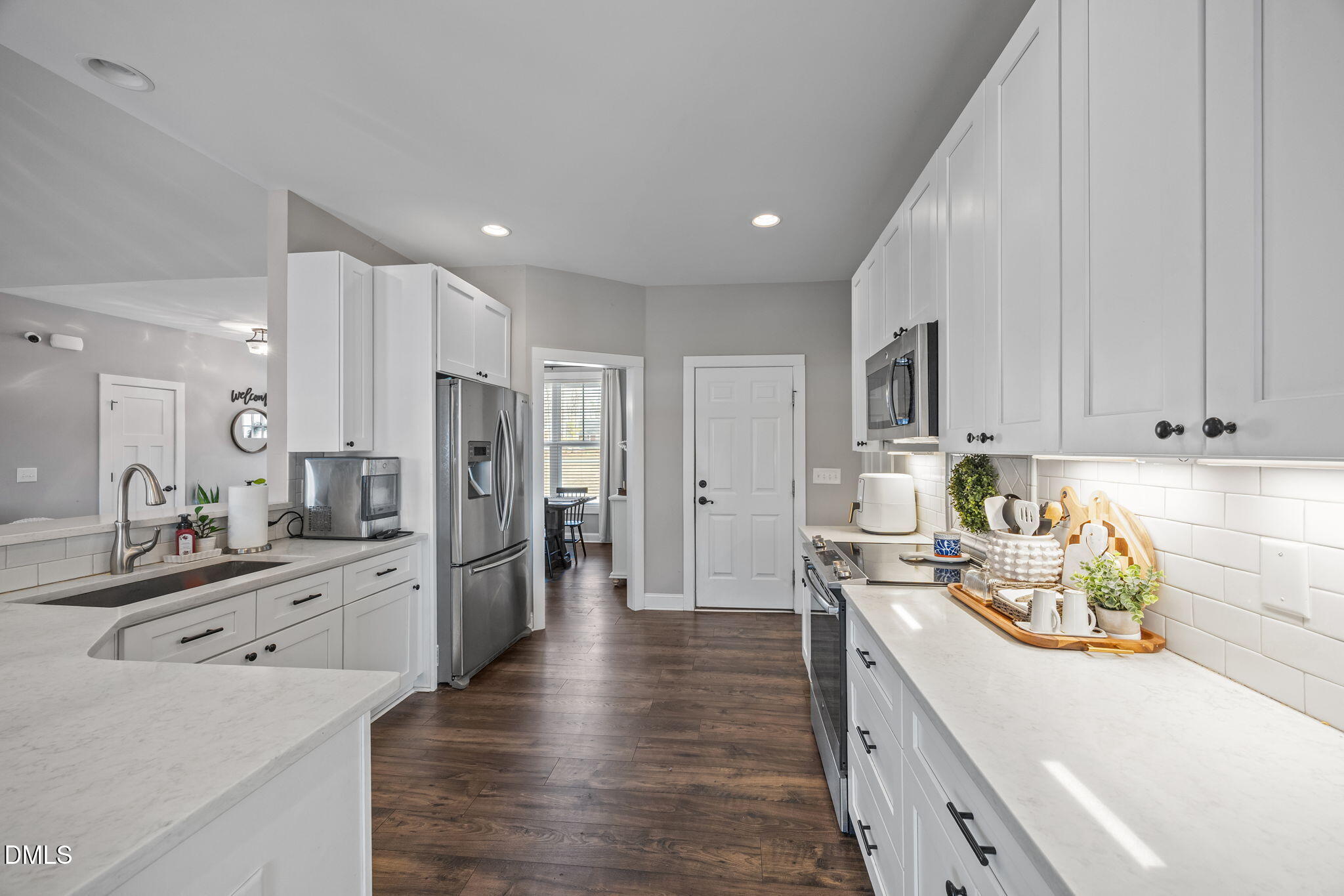 2265 Lacy Holt Road Graham, NC 27253 - Photo 22 of 43 a kitchen with stainless steel appliances kitchen island granite countertop a refrigerator stove and sink