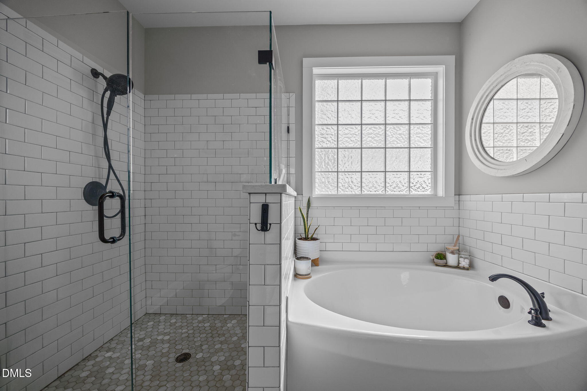 2265 Lacy Holt Road Graham, NC 27253 - Photo 29 of 43 a bathroom with a tub a window and a shower