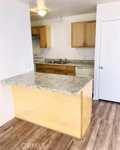 a view of kitchen and wooden floor