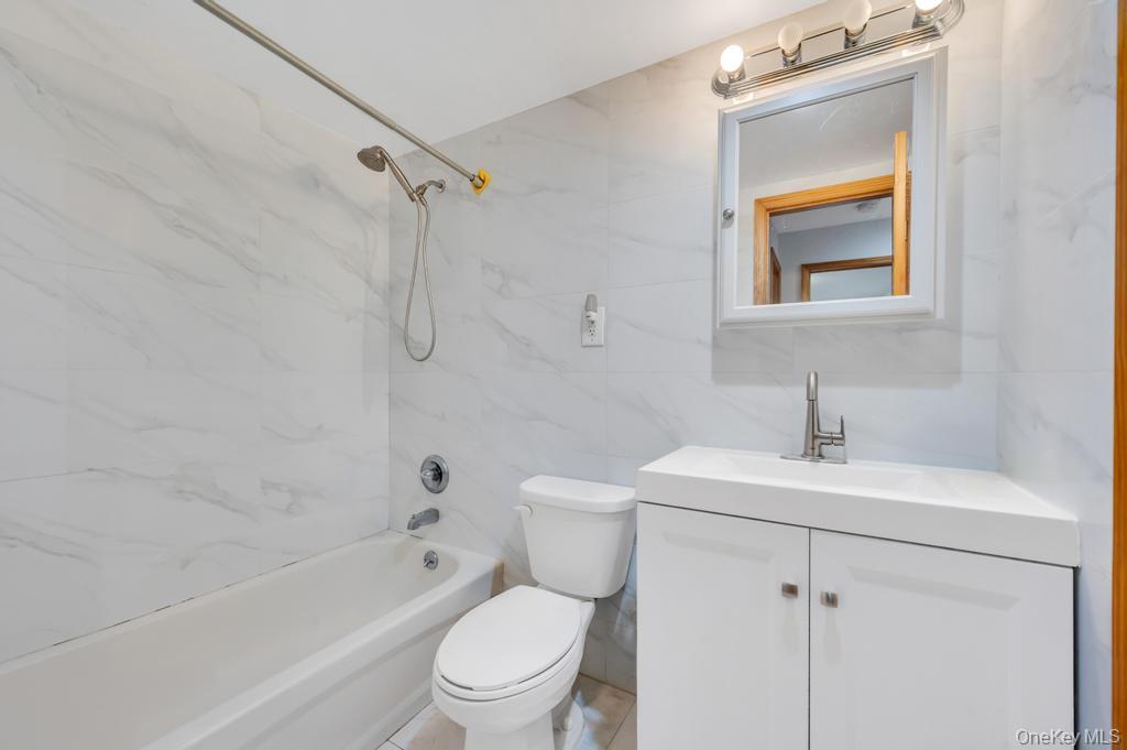 42-11 108th Street, Unit 1A Queens, NY 11368 - Photo 11 of 16 a bathroom with a sink toilet and shower