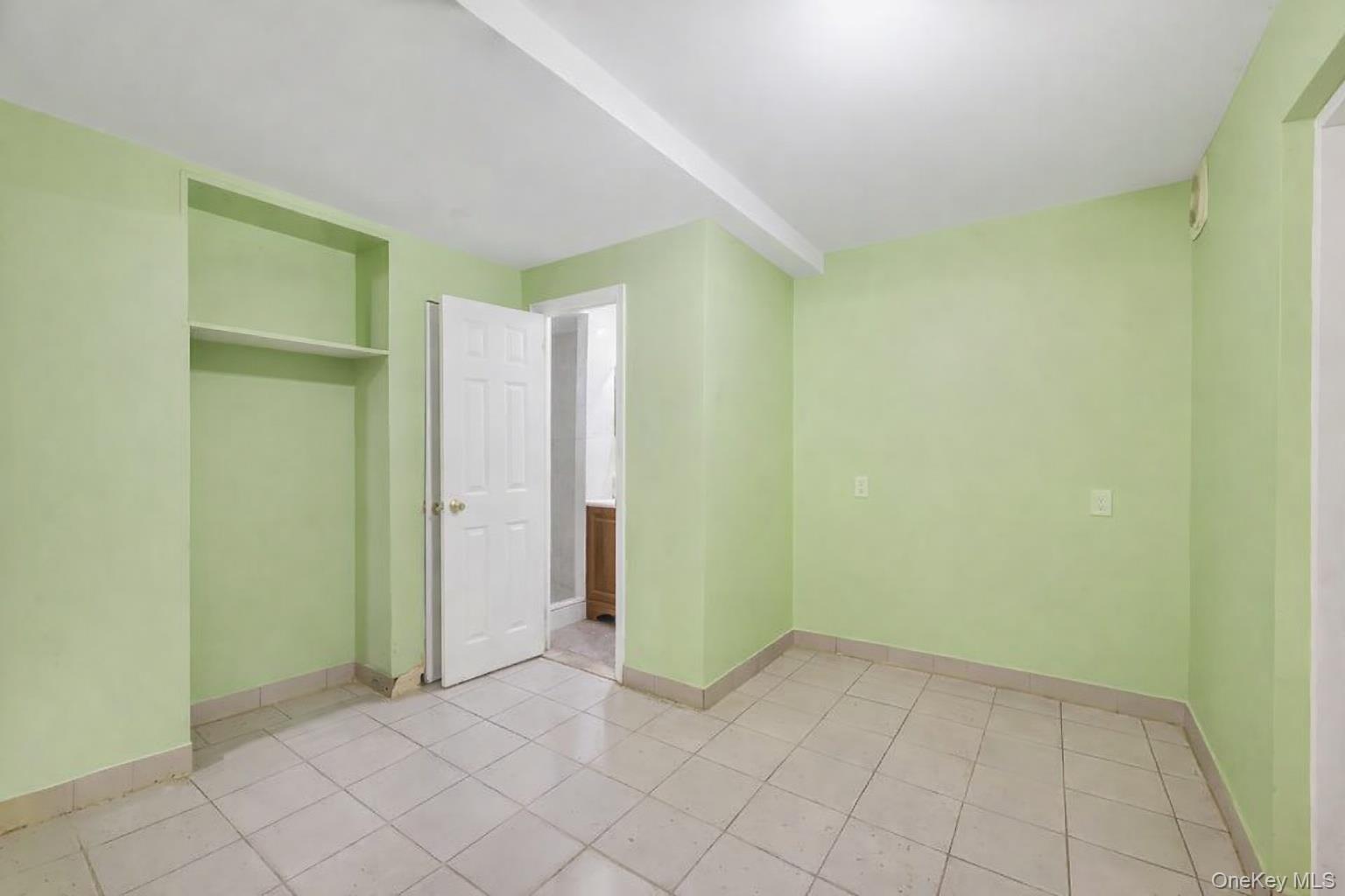 42-11 108th Street, Unit 1A Queens, NY 11368 - Photo 12 of 16 a view of an empty room with windows