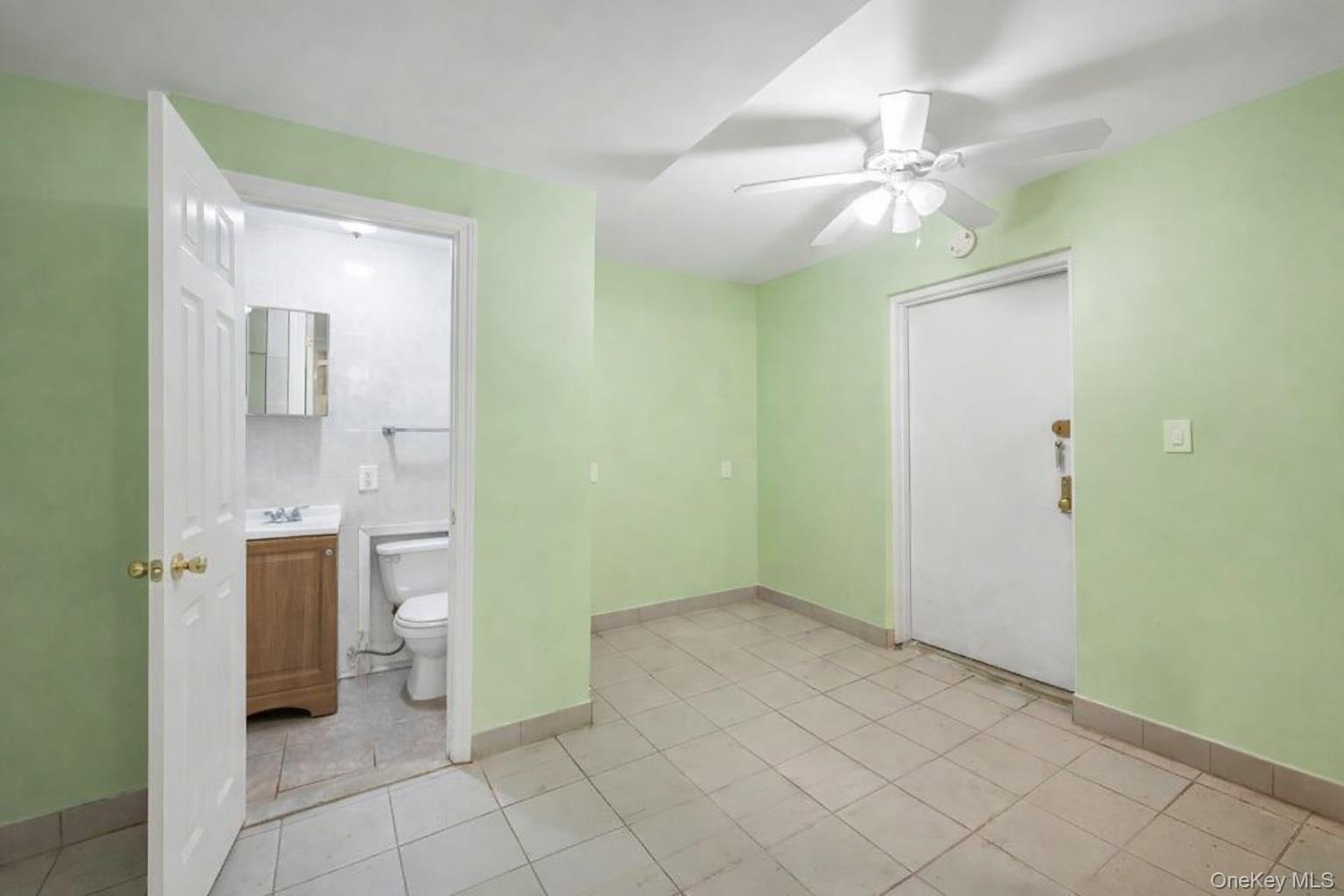 42-11 108th Street, Unit 1A Queens, NY 11368 - Photo 13 of 16 a view of a bathroom with a mirror and a shower