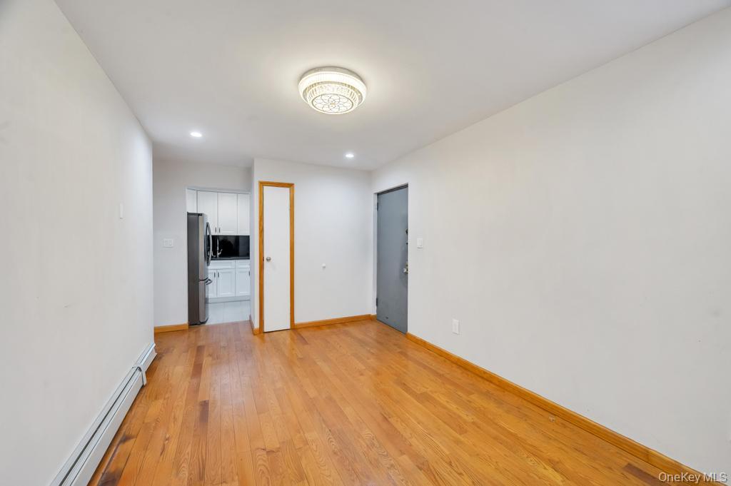 42-11 108th Street, Unit 1A Queens, NY 11368 - Photo 6 of 16 a view of empty room with wooden floor