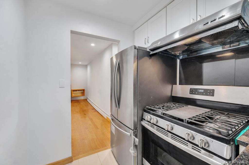42-11 108th Street, Unit 1A Queens, NY 11368 - Photo 8 of 16 a kitchen with a stove and a refrigerator