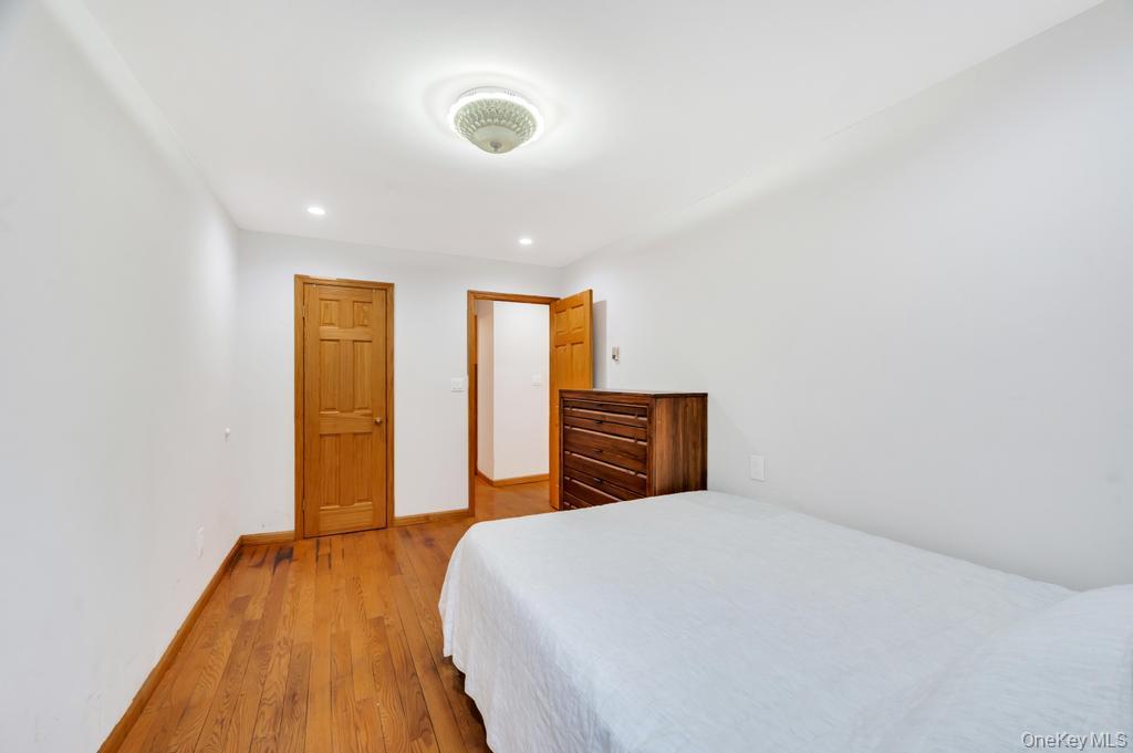 42-11 108th Street, Unit 1A Queens, NY 11368 - Photo 10 of 16 a view of bedroom with natural light and wooden floor