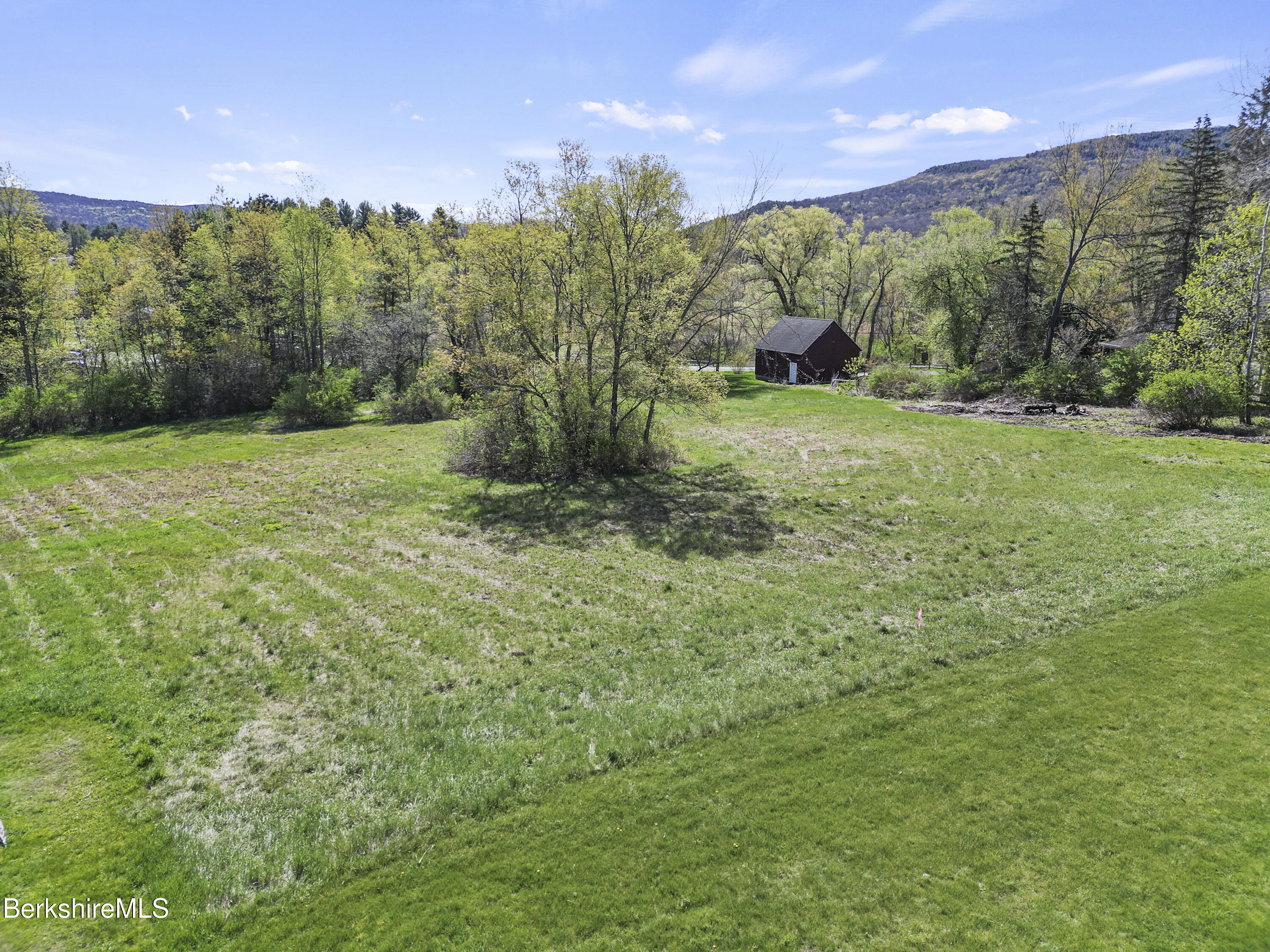 0 Church Street Lee, MA 01238 - Photo 9 of 16 a view of a green field with trees in the background