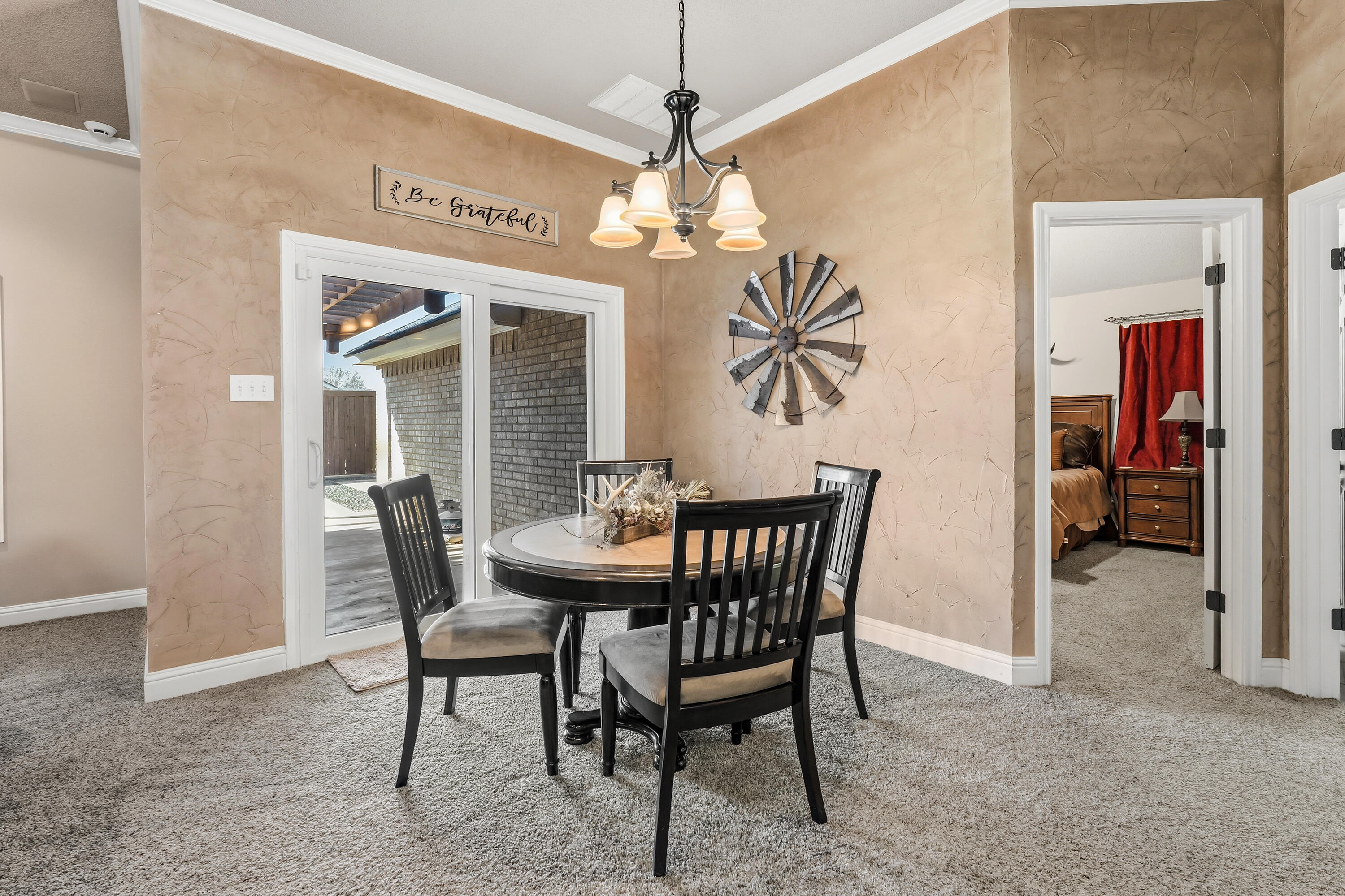 3017 104th Street Lubbock, TX 79423 - Photo 11 of 28 a view of a dining room with furniture and a chandelier