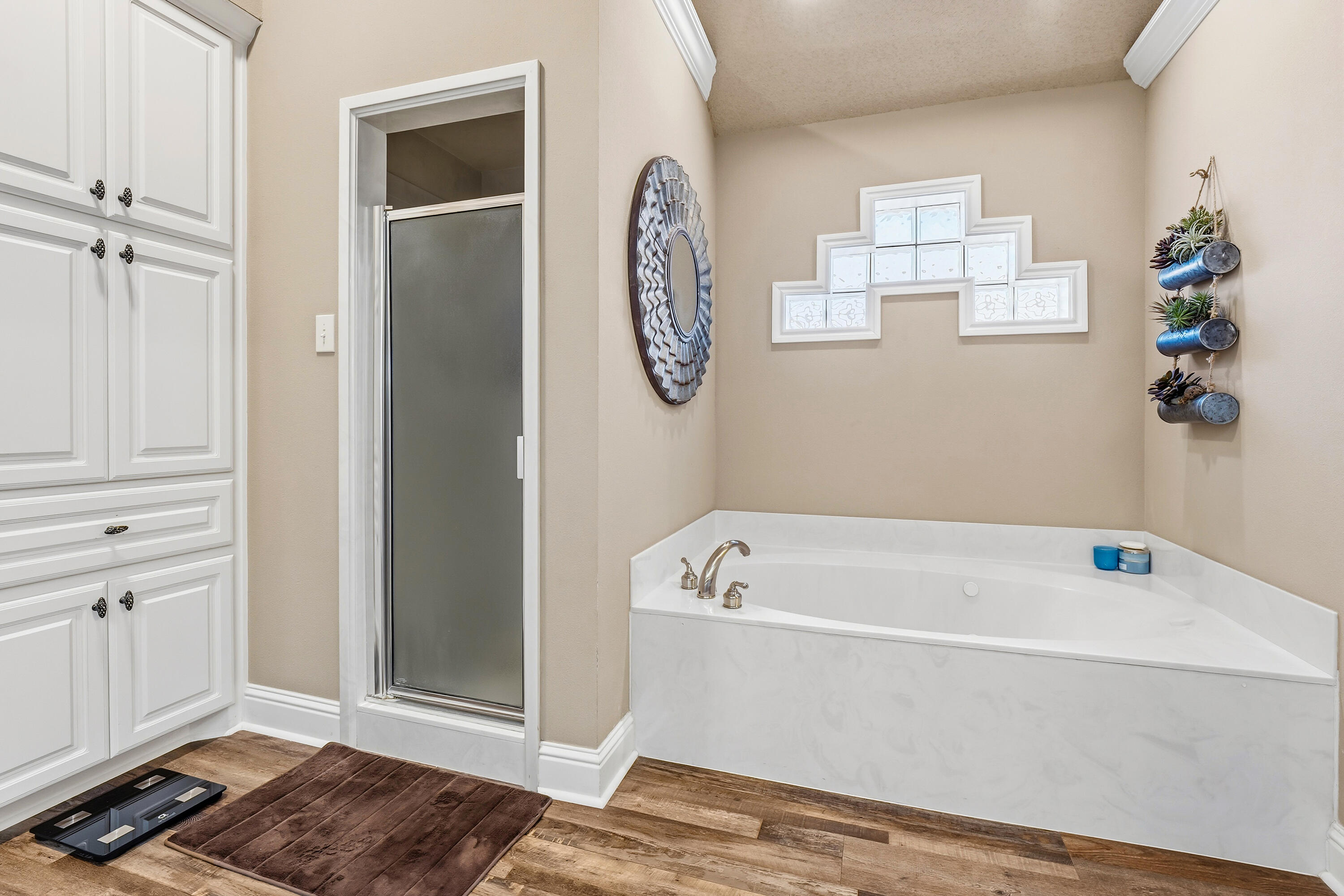 3017 104th Street Lubbock, TX 79423 - Photo 18 of 28 a bathroom with a bathtub and a window
