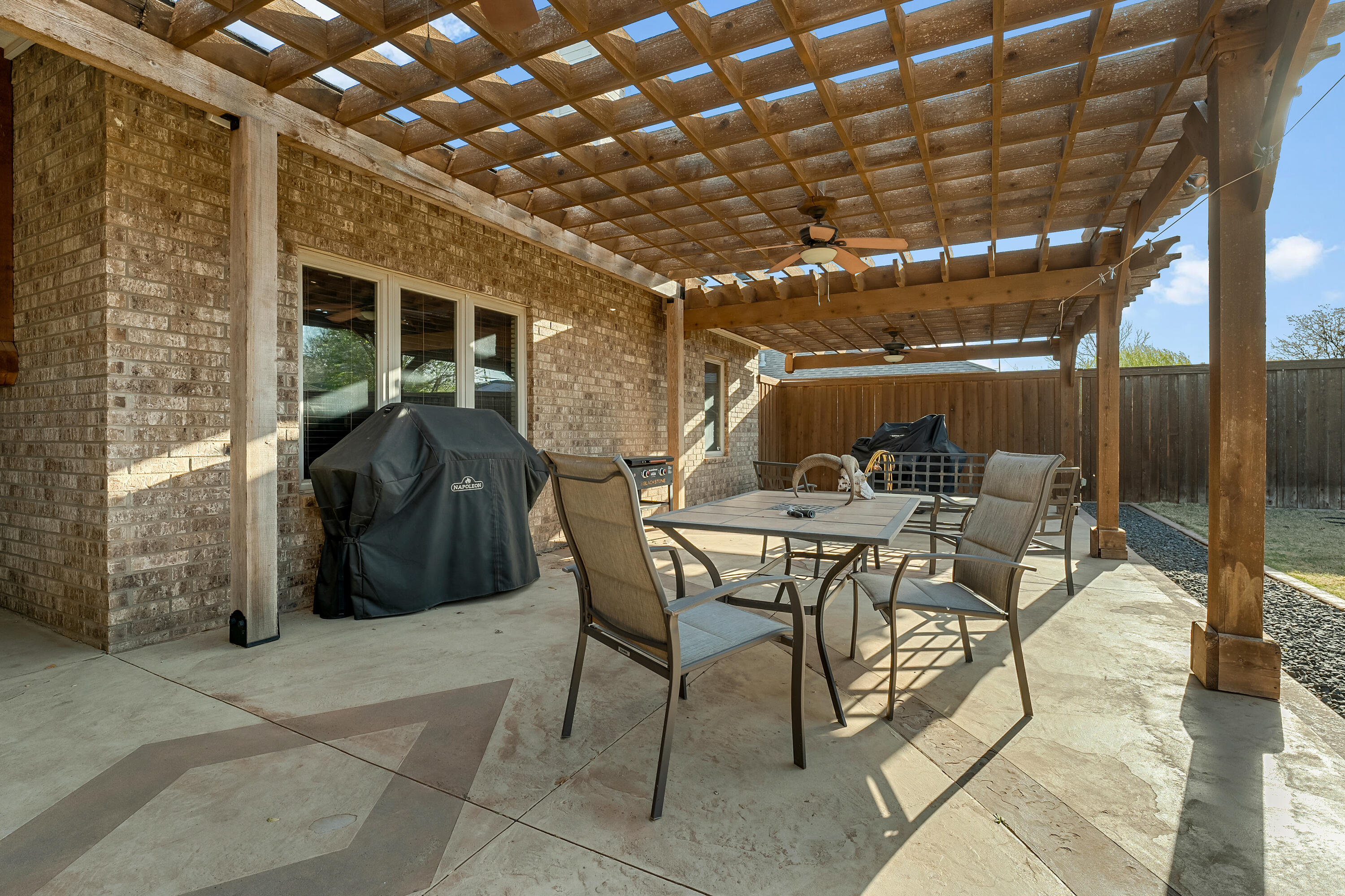 3017 104th Street Lubbock, TX 79423 - Photo 25 of 28 a view of a dinning table and chairs in patio