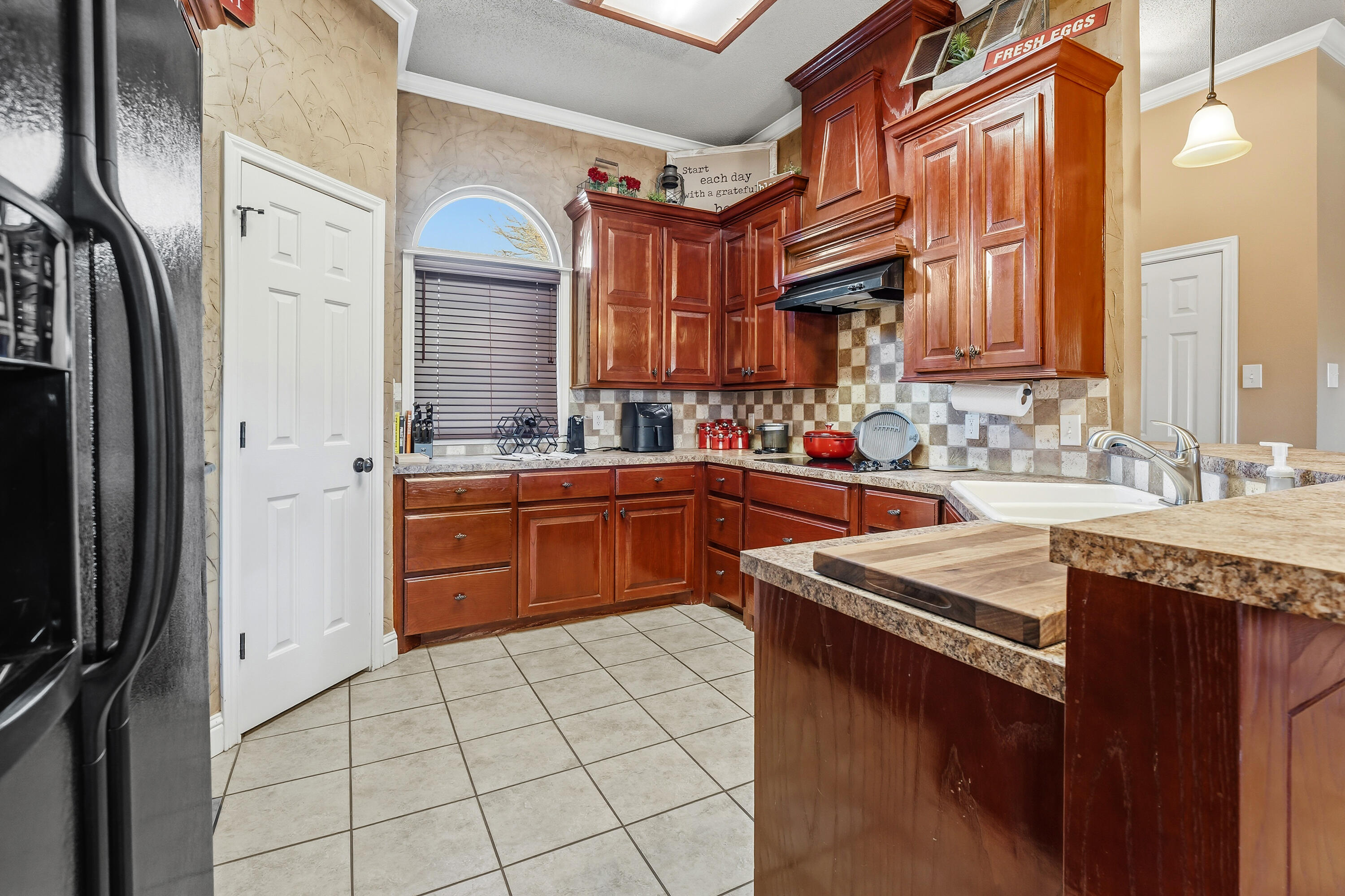 3017 104th Street Lubbock, TX 79423 - Photo 8 of 28 a kitchen with stainless steel appliances granite countertop a sink stove and refrigerator