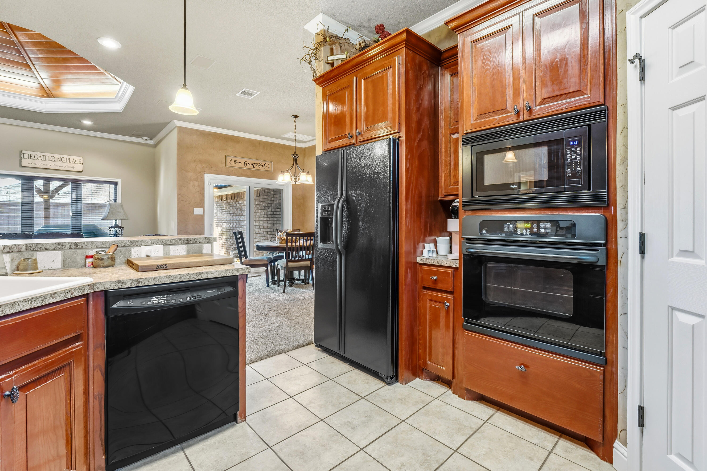 3017 104th Street Lubbock, TX 79423 - Photo 9 of 28 a kitchen with granite countertop a refrigerator stove and oven