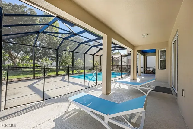 a view of yard with a table and chairs under an umbrella