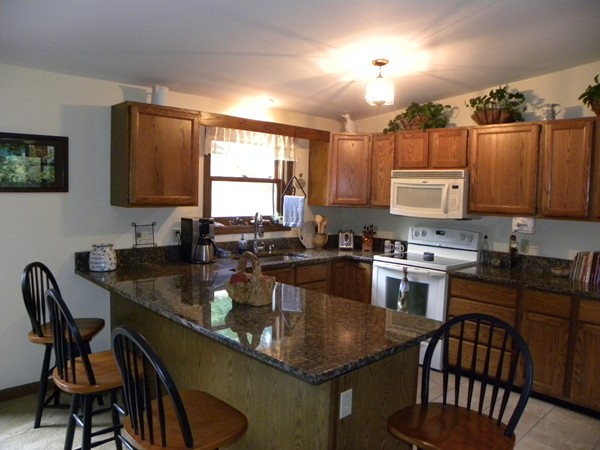 69 Gale Road Charlton, MA 01507 - Photo 9 of 30 a kitchen with a granite countertop sink table and chairs