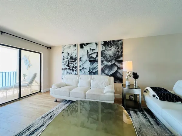a bedroom with a bed and a flat tv screen on dresser
