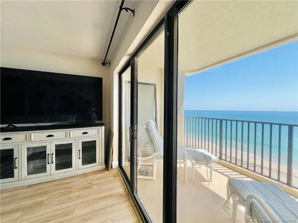a bedroom with a bed and a flat tv screen on dresser