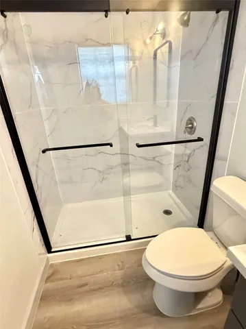 a bathroom with a toilet and a shower