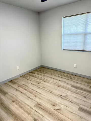 a view of a room with wooden floor and cabinet