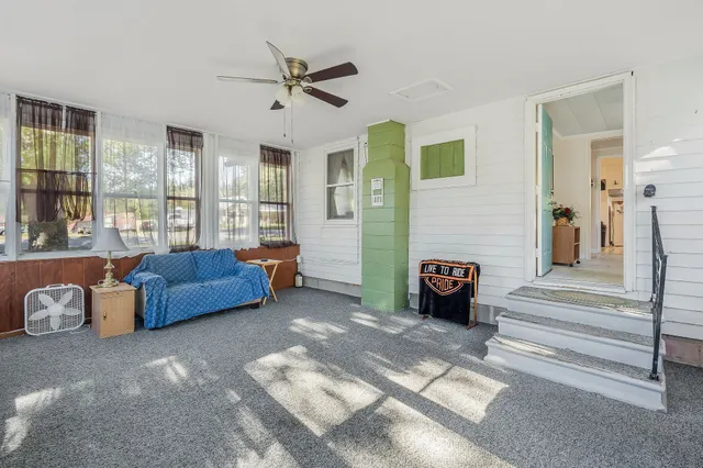 a living room with furniture and a floor to ceiling window