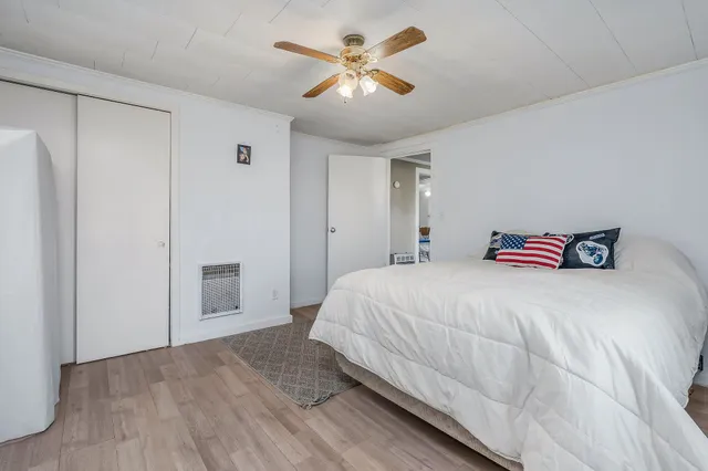 a bedroom with a bed and a ceiling fan