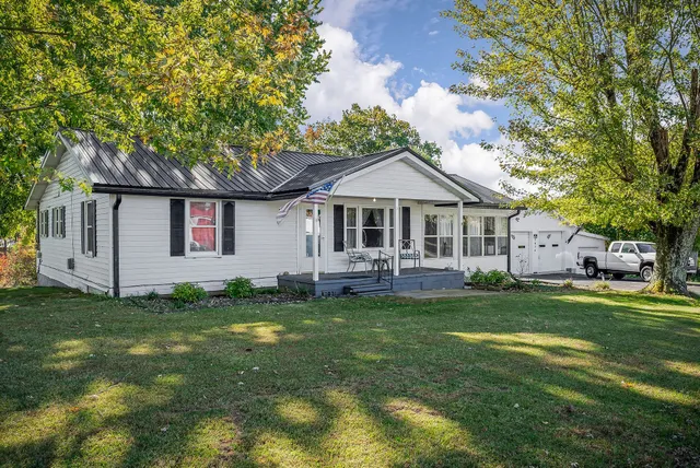 a front view of house with yard and green space