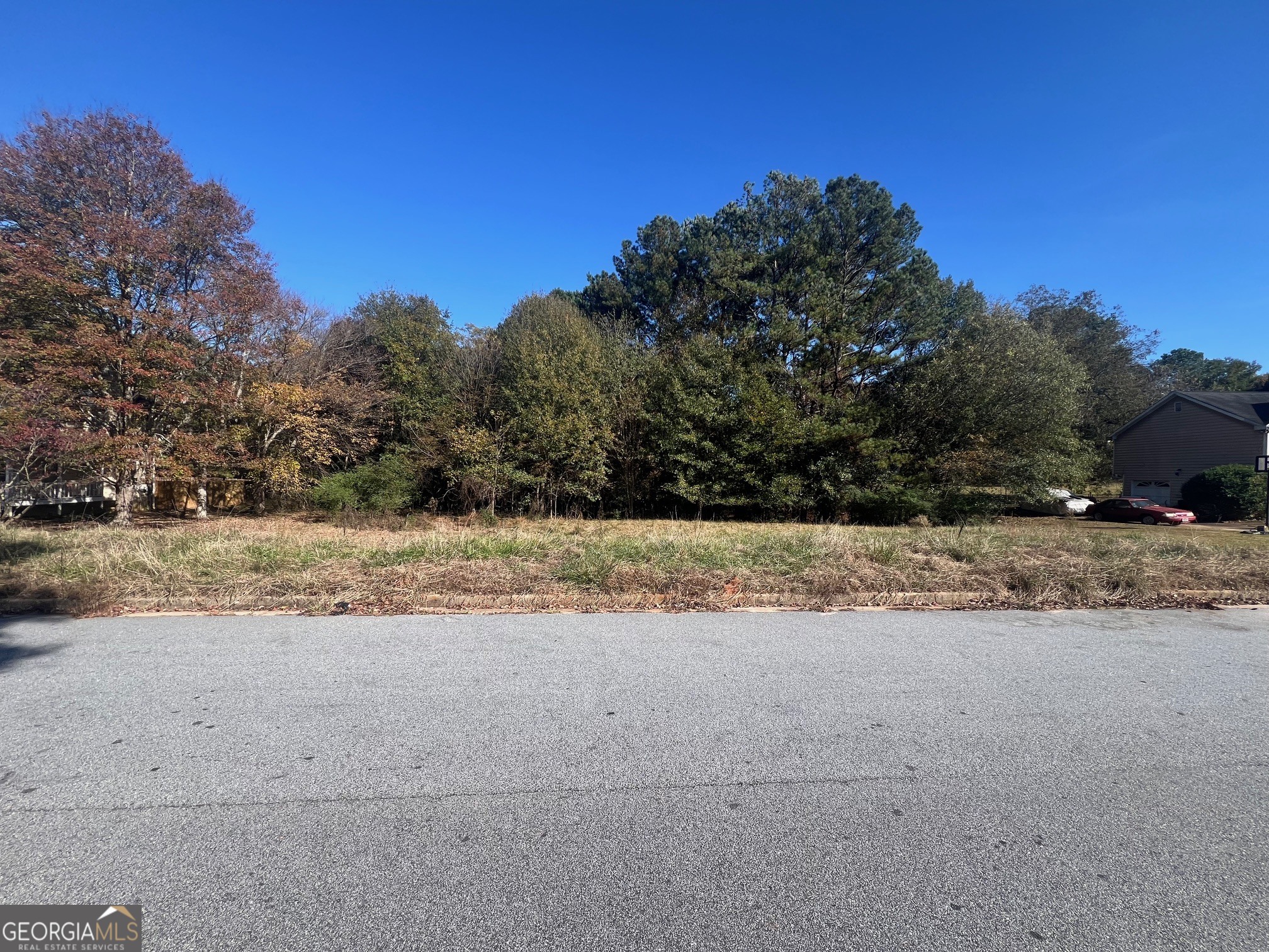 40 Bentley Pl Way Covington, GA 30016 - Photo 3 of 4 a view of dirt road with a building in the background