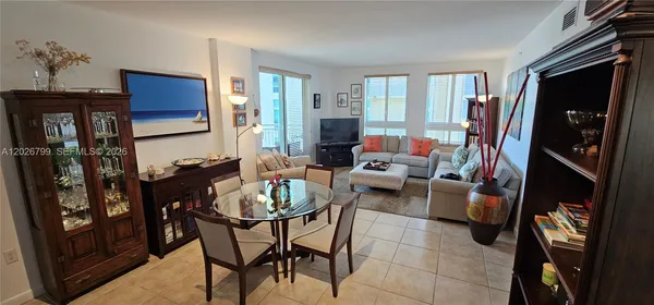 a living room with furniture a rug and a window