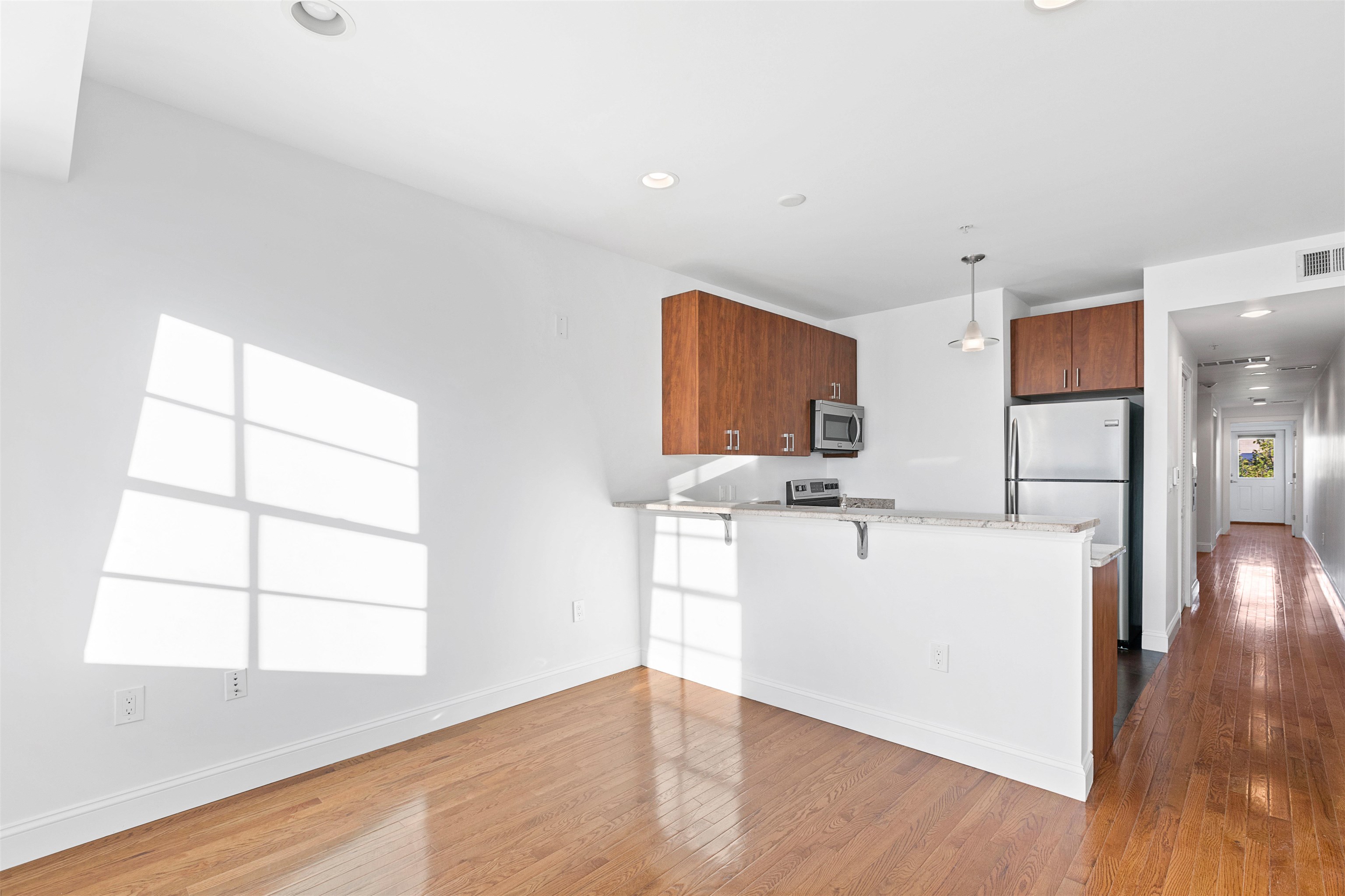 415 Jackson Street, Unit 4R Hoboken, NJ 07030 - Photo 3 of 13 a kitchen with stainless steel appliances a stove top oven a sink a refrigerator and a window