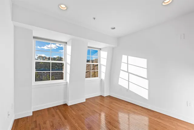 a bathroom with a granite countertop sink a toilet a mirror and shower