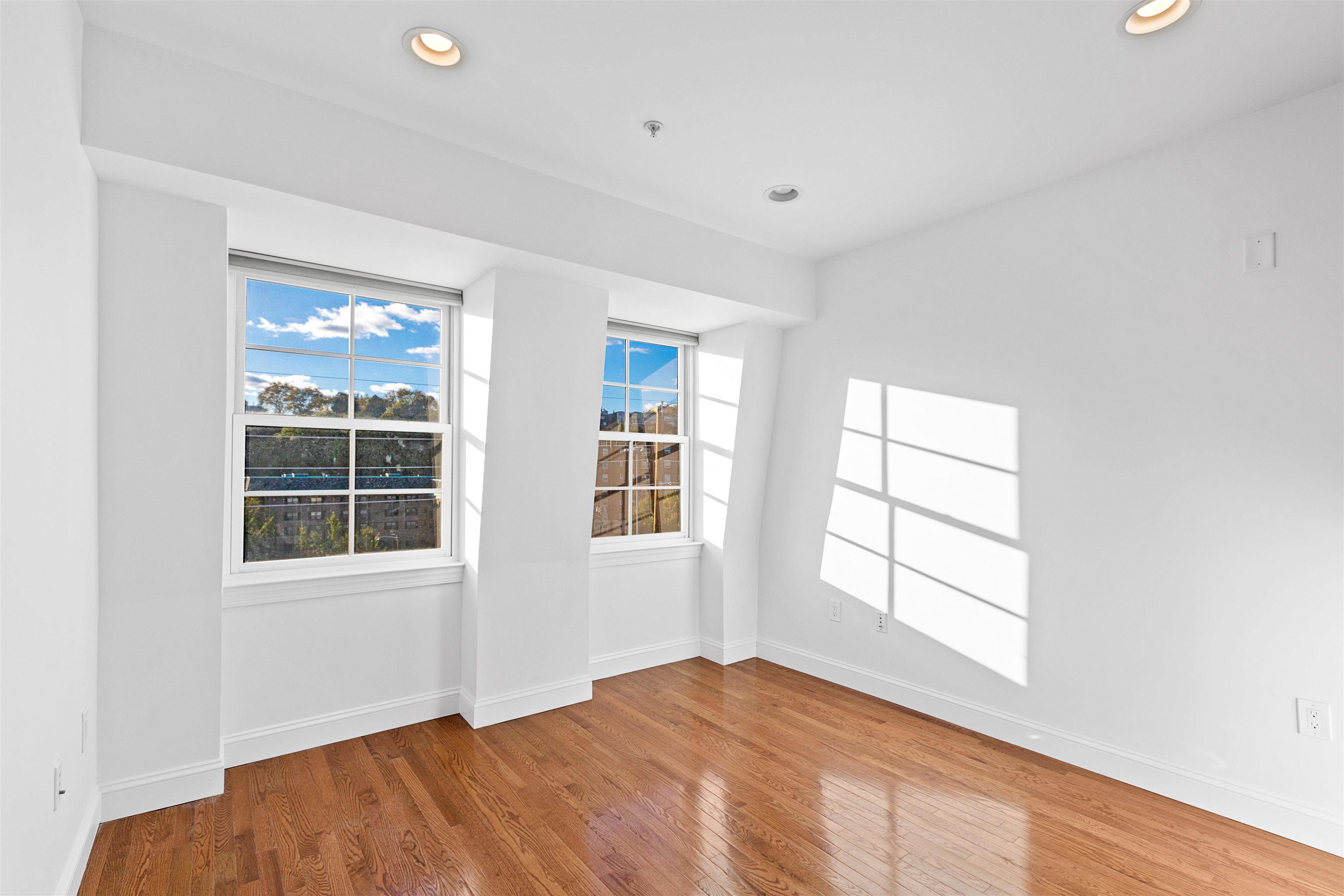 415 Jackson Street, Unit 4R Hoboken, NJ 07030 - Photo 6 of 13 an empty room with windows