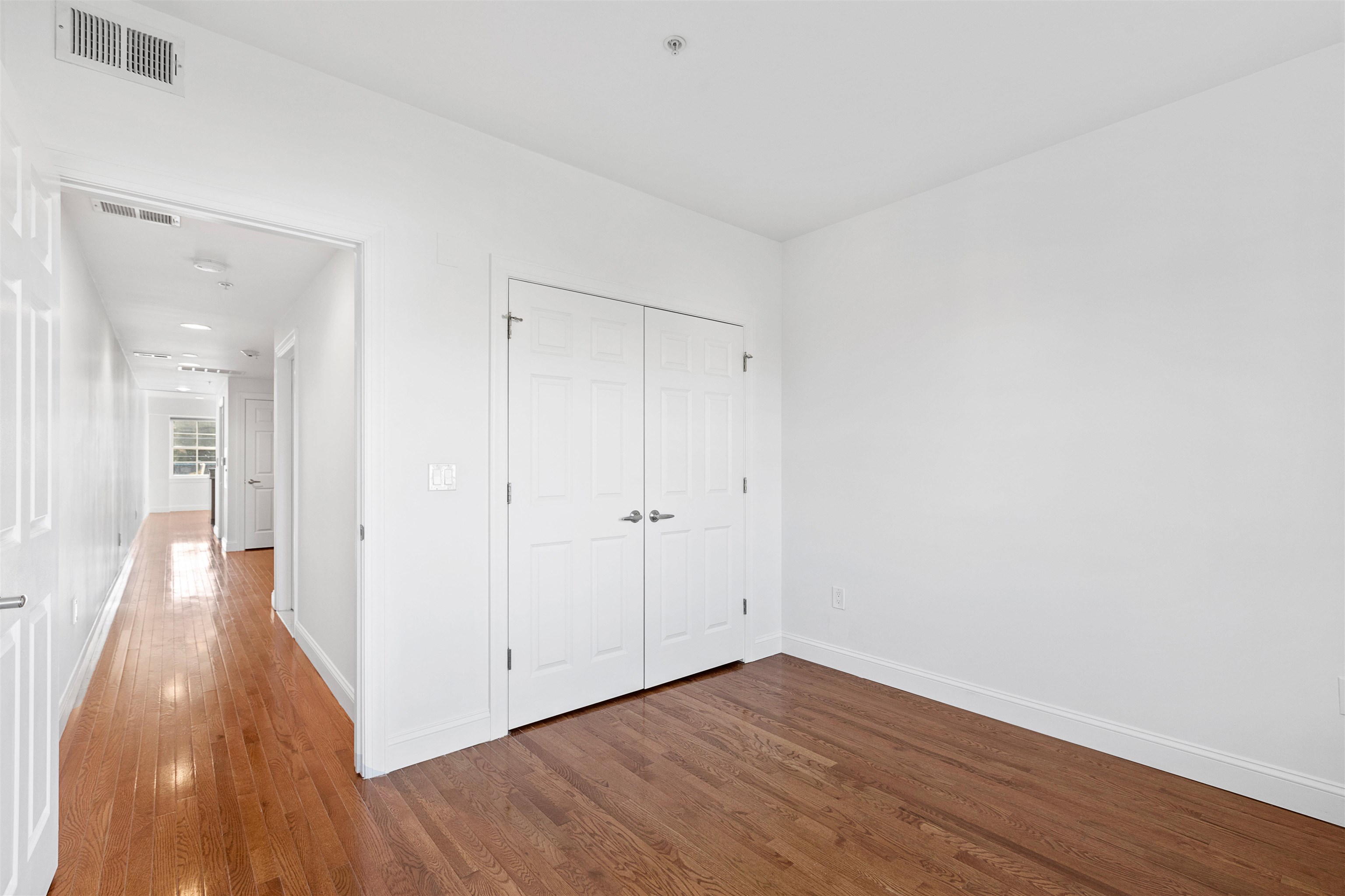 415 Jackson Street, Unit 4R Hoboken, NJ 07030 - Photo 9 of 13 a view of a hallway with wooden floor