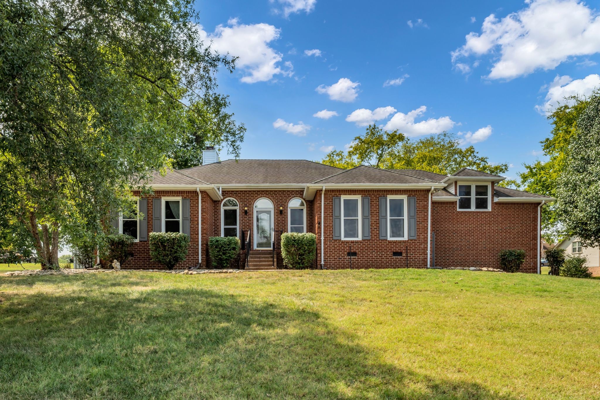 a front view of house with yard and green space