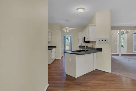 a kitchen with granite countertop a sink and a stove top oven