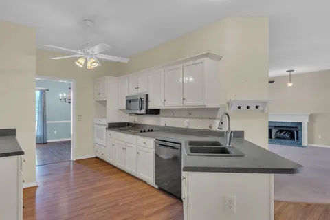 a kitchen with stainless steel appliances granite countertop a sink a stove and a refrigerator