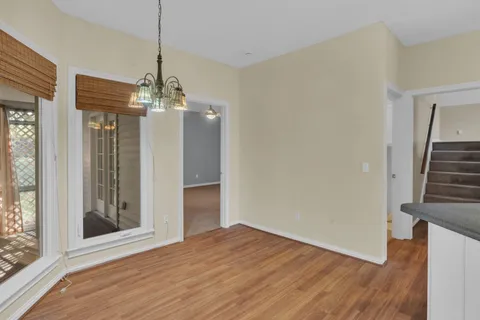 a view of a room with wooden floor and staircase