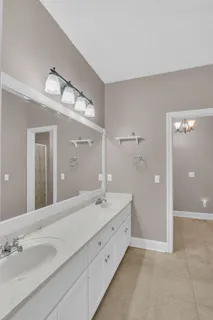 a spacious bathroom with a double vanity sink and a mirror