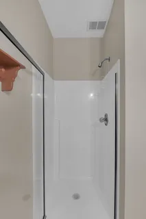 a bathroom with a glass shower door