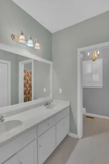 a bathroom with a double vanity sink and mirror