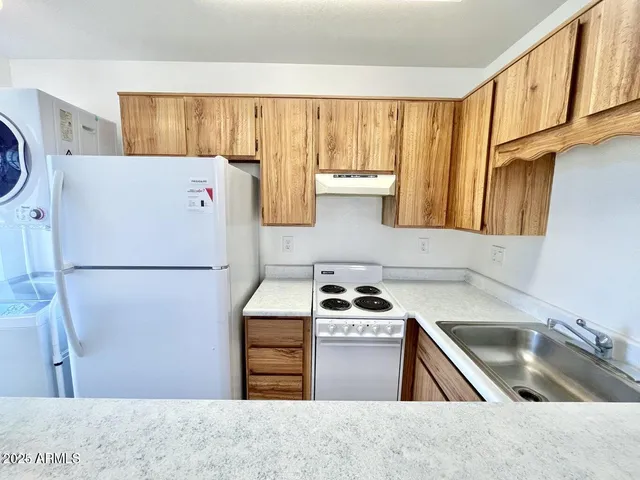 a kitchen with a refrigerator and a sink