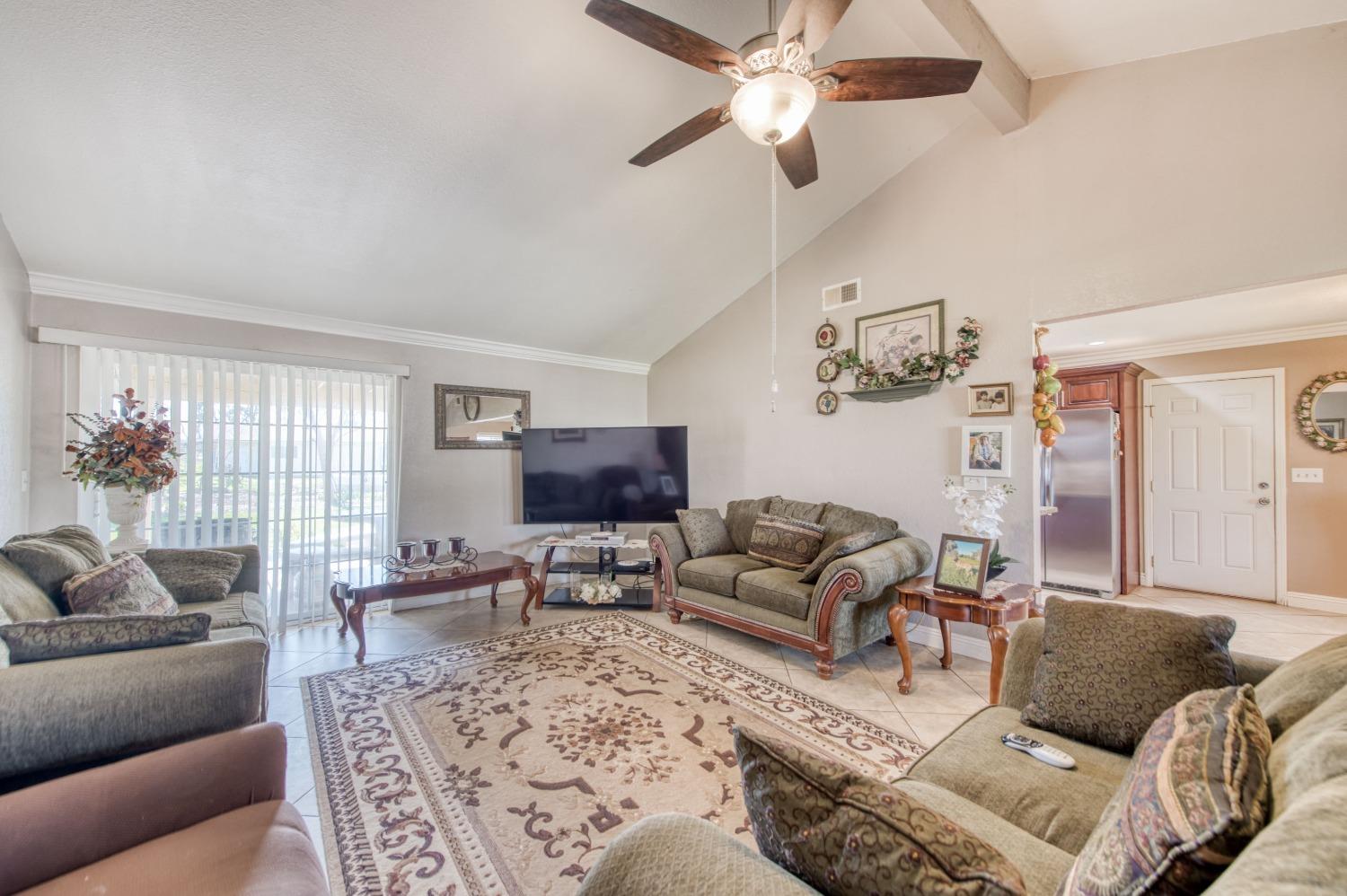 25540 Lynn Place, Unit B Madera, CA 93638 - Photo 11 of 37 a living room with furniture and a flat screen tv