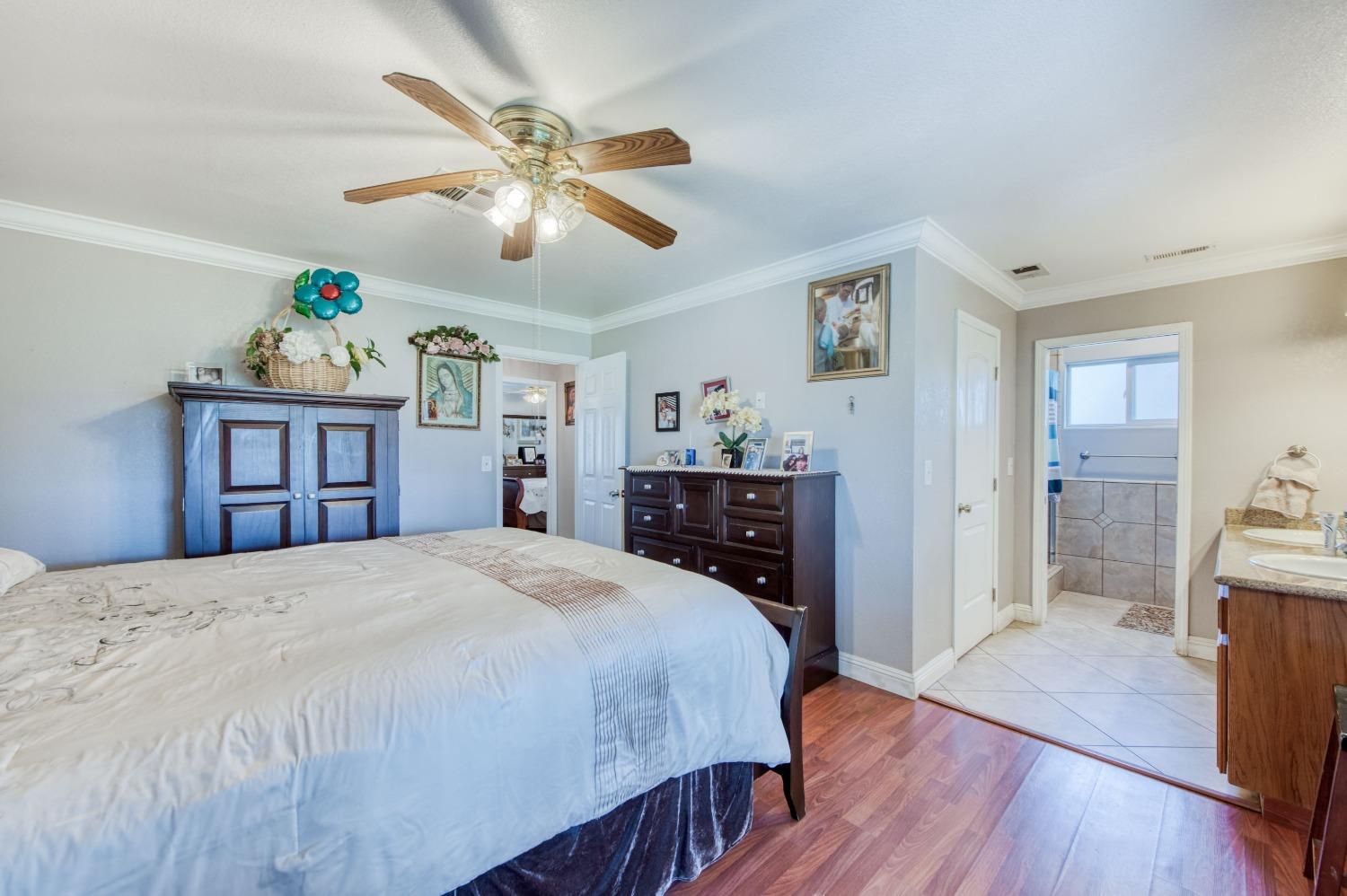 25540 Lynn Place, Unit B Madera, CA 93638 - Photo 19 of 37 a bedroom with a bed and a dresser