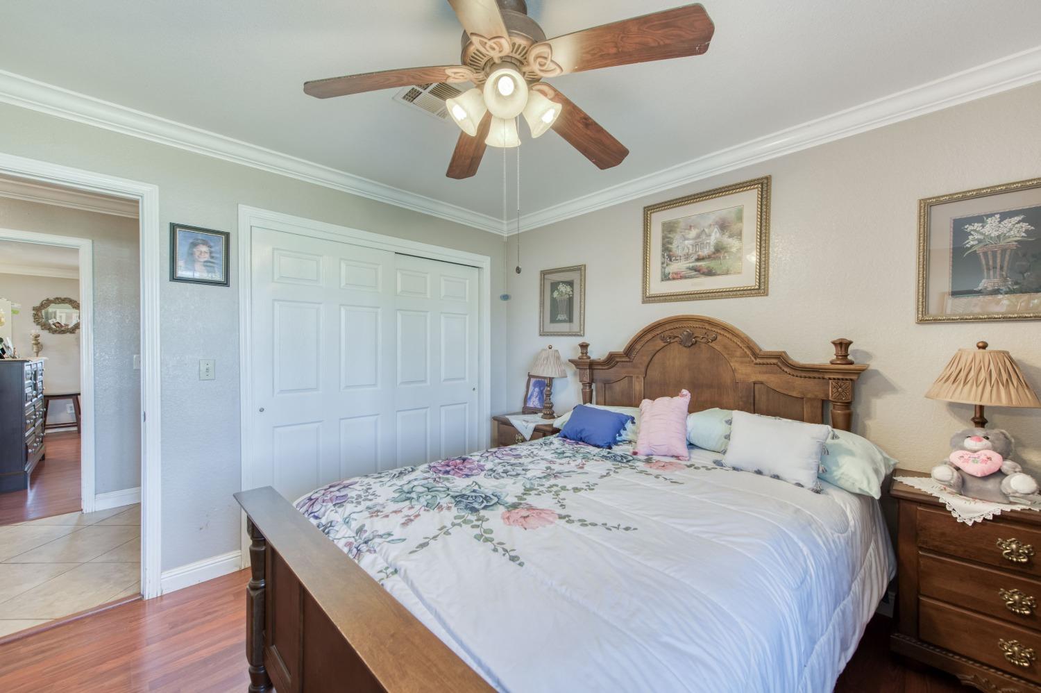 25540 Lynn Place, Unit B Madera, CA 93638 - Photo 22 of 37 a bedroom with a bed and wooden floor