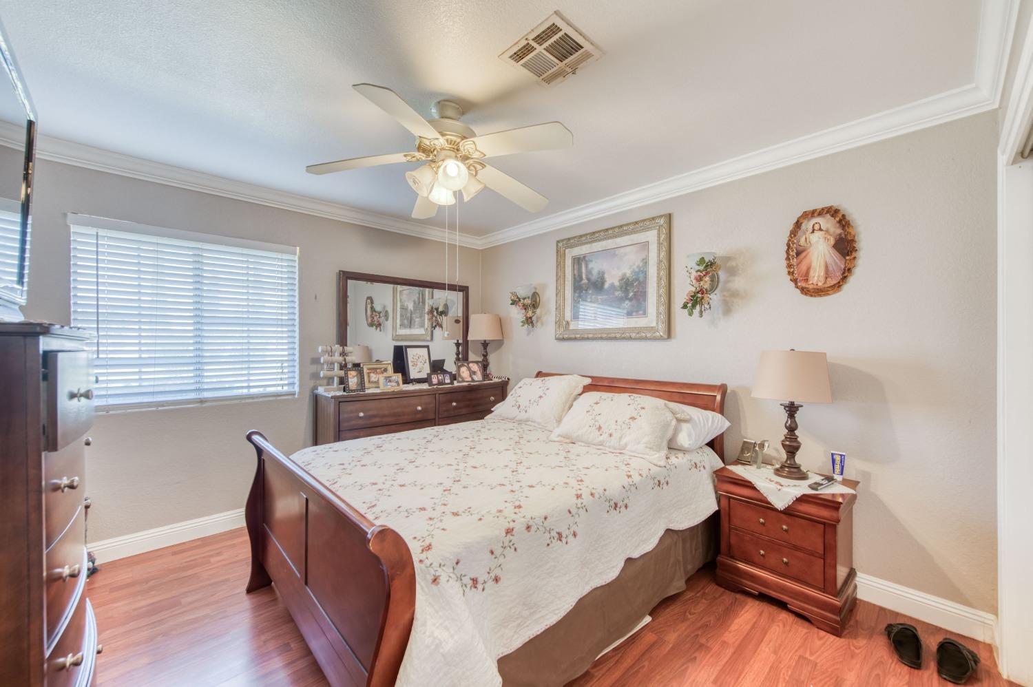 25540 Lynn Place, Unit B Madera, CA 93638 - Photo 23 of 37 a bed room with a bed and a chandelier